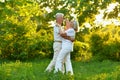 Happy beautiful senior couple dancing in summer park Royalty Free Stock Photo