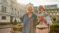 Happy and beautiful senior couple holding hands and smiling while standing outdoors together Royalty Free Stock Photo