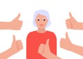 Happy beautiful senior woman collects like. Elderly woman surrounds hands showing thumbs up. Social approval, positive