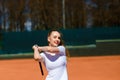 Happy beautiful sexy girl playing tennis on the court. Sport and recreation, leisure Royalty Free Stock Photo