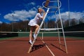 Happy beautiful sexy girl playing tennis on the court. Sport and recreation, leisure Royalty Free Stock Photo