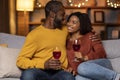 Happy beautiful smiling black couple drinking red wine at home Royalty Free Stock Photo