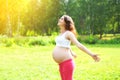 Happy beautiful smiling pregnant woman enjoys summer day Royalty Free Stock Photo