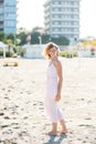 Happy beautiful smiling young woman walk at the sand beach, looking at camera Royalty Free Stock Photo