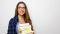 Happy beautiful student girl with stack of books in her hands. Studio shot on white background. Copy space. Back to school or Royalty Free Stock Photo