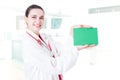 Happy beautiful surgeon holding empty paper Royalty Free Stock Photo