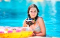 Happy beautiful teen girl smiling at the pool