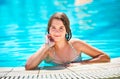 Happy beautiful teen girl smiling at the pool