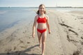 Beautiful teen girl walking on beach at sea at summer holidays Royalty Free Stock Photo