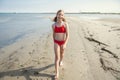 Beautiful teen girl walking on beach at sea at summer holidays Royalty Free Stock Photo
