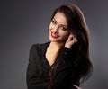 Happy beautiful toothy smiling woman with long hair style in fashion black shirt looking on dark shadow background. Closeup Royalty Free Stock Photo