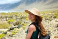 Happy beautiful traveler girl with straw hat looking to the camera. Young female backpacker exploring Lanzarote, Canary Islands.