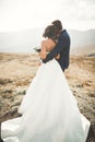 Happy beautiful wedding couple bride and groom at wedding day outdoors on the mountains rock. Happy marriage couple Royalty Free Stock Photo