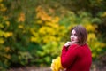 Happy beautiful woman in autumn, cute plus size model in red sweater outdoors with copy space