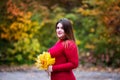 Happy beautiful woman in autumn, cute plus size model in red sweater outdoors