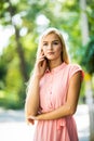 Happy young beautiful woman calling by phone in autumn on wall leaves green Royalty Free Stock Photo