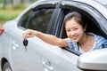 Happy beautiful woman driver holding keys her new car with smiling. Young woman with the keys at the car. Concept of having a new Royalty Free Stock Photo