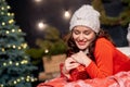 Happy beautiful woman holding Christmas present with her eyes closed Royalty Free Stock Photo