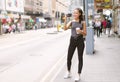 Happy beautiful woman holding coffee hot cup and taking photo with mobile phone in Central walking in streets, travel guide,