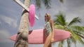 Happy beautiful woman with pink surfboard walking to the beach Royalty Free Stock Photo