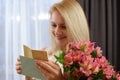 Happy beautiful woman reads a love letter. girl reads note from her beloved boyfriend. Royalty Free Stock Photo