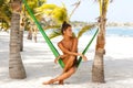 Happy and beautiful woman is sitting in the hammock Royalty Free Stock Photo