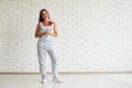 Happy beautiful woman standing and holding red paper heart Royalty Free Stock Photo