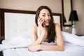 Happy beautiful woman talking on the phone at home in the morning Royalty Free Stock Photo