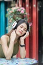 Happy beautiful woman using headphone listening music outdoor, l Royalty Free Stock Photo