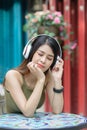 Happy beautiful woman using headphone listening music outdoor, l Royalty Free Stock Photo