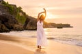 Happy woman walking on beach at sunset Royalty Free Stock Photo