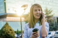 Happy beautiful woman walking and writing or reading sms message on line on a smart phone Royalty Free Stock Photo