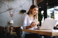 Happy young beautiful woman working, surfing, studying on laptop Royalty Free Stock Photo