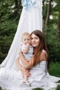 Happy beautiful woman, young mother playing with her adorable baby son, cute little boy, enjoying together a sunny warm Royalty Free Stock Photo