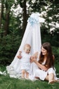 Happy beautiful woman, young mother playing with her adorable baby son, cute little boy, enjoying together a sunny warm Royalty Free Stock Photo