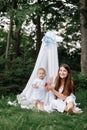 Happy beautiful woman, young mother playing with her adorable baby son, cute little boy, enjoying together a sunny warm Royalty Free Stock Photo