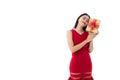 Happy beautiful young Asian woman in business red dress is smiling, holding gold presents, gifts boxes with red ribbon while she Royalty Free Stock Photo