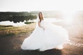 Happy beautiful young bride outside on a summer meadow at the sunset Royalty Free Stock Photo