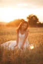 Happy beautiful young bride outside on a summer meadow at the sunset Royalty Free Stock Photo