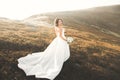 Happy beautiful young bride outside on a summer meadow at the sunset Royalty Free Stock Photo