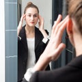 Happy beautiful young business woman checking her makeup on morning Royalty Free Stock Photo