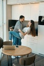 Happy beautiful young couple dancing tango in the kitchen Royalty Free Stock Photo