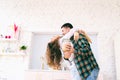 Happy beautiful young couple have fun in the kitchen, dancing, cuddling, cooking food together Royalty Free Stock Photo