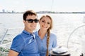 Happy and beautiful young couple having a rest on a yacht. Traveling, tourism, journey, concept.