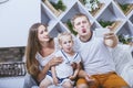 Happy beautiful young family father, mother and daughter are doing selfie on mobile smile at home Royalty Free Stock Photo