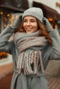 Happy beautiful young girl with a smile in a gray trendy coat Royalty Free Stock Photo