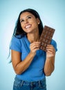 Young attractive brunette feeling joy and guilt at the thought of eating chocolate Royalty Free Stock Photo