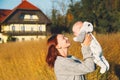 Happy beautiful young mother with her baby child on nature.