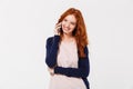 Happy beautiful young redhead lady talking by mobile phone. Royalty Free Stock Photo