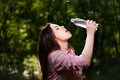 Happy beautiful young thirsty woman drinking water. Royalty Free Stock Photo